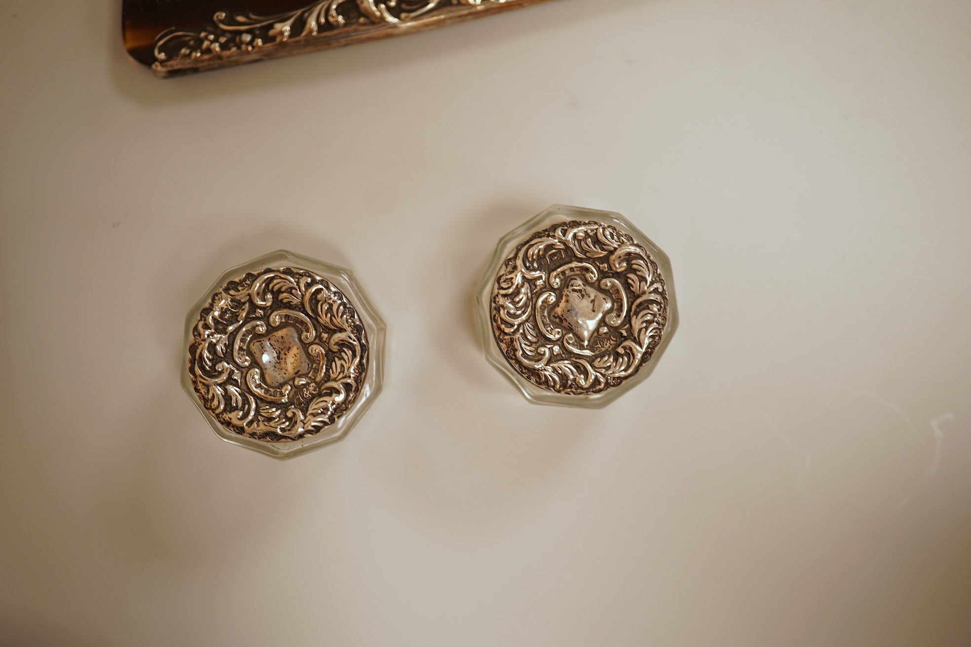 A pierced 800 standard white metal fruit bowl, diameter 23.6cm, a silver mounted hand mirror and two brushes, a 19th century continental white metal pyx, a pair of George V silver mounted whisky noggins, Birmingham, 1925